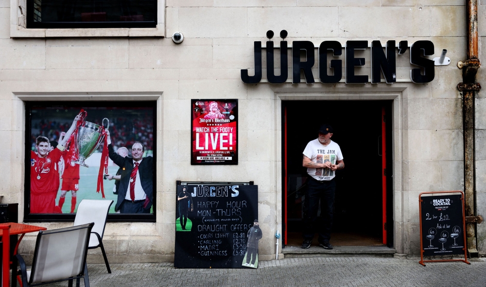 A person stands in the doorway of a bar in Liverpool city centre called Jurgen's before Juergen Klopp's final match as Liverpool manager, Liverpool, Britain, May 16, 2024. — Reuters pic
