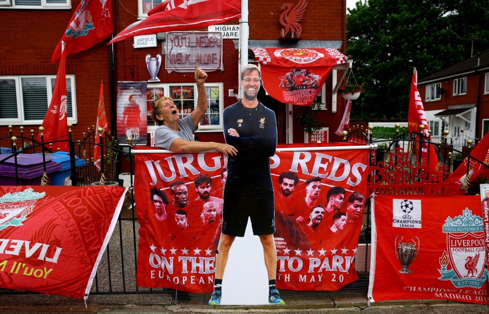 Emily Farley shouts at a passer-by as she decorates her house in Liverpool before Juergen Klopp's final match as Liverpool manager, Liverpool, Britain, May 16, 2024. — Reuters pic